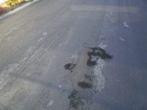 Severely Damaged Oil Spot in Asphalt