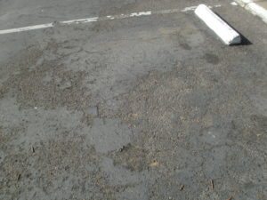 Moderate Damage to Asphalt Caused by Oil Spots